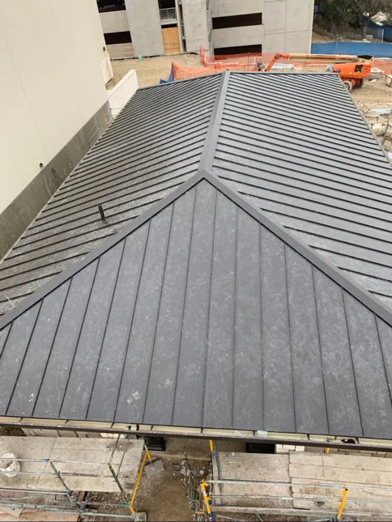 Commercial metal roof construction with crane equipment in Upper Uwchlan